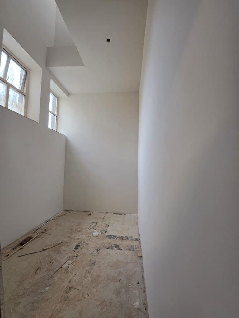 Hoge kamer met twee raampartijen, gestuct